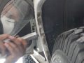 Using hacksaw to cut second inner fender