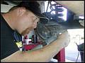 RE8003 Installing lower control arm axle side.